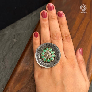 Ira stone set in 92.5 silver with green flower highlight.
Beautiful adjustable ring perfect to add drama to your outfit.