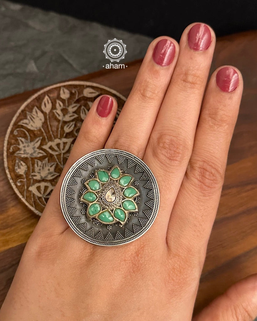 Ira stone set in 92.5 silver with green flower highlight.
Beautiful adjustable ring perfect to add drama to your outfit.