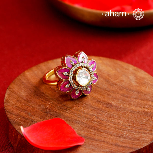 This exquisite ring features a dazzling moissanite center set within an elegant flower design, accented by vibrant fuchsia pink stones. Crafted from 92.5% sterling silver and enhanced with a refined gold polish, for a luxurious finish. Perfect for those seeking a sophisticated blend of classic craftsmanship and contemporary style.