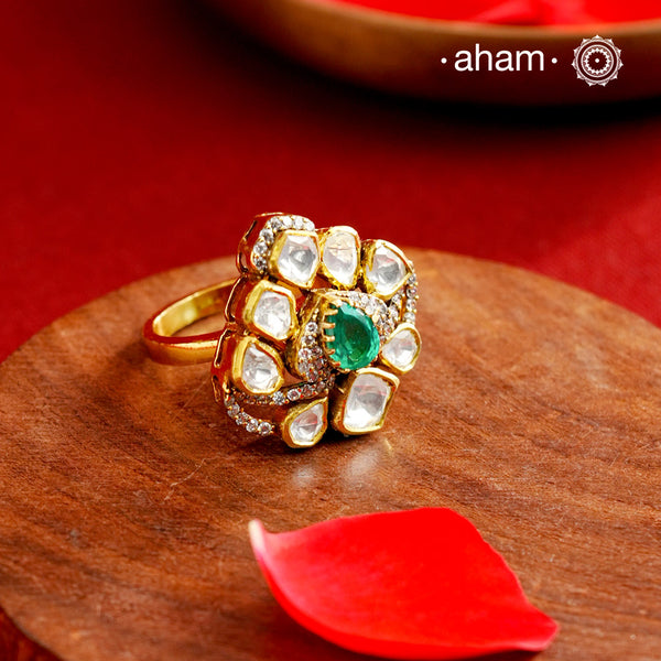 Crafted from 92.5% sterling silver with a rich gold polish, this ring showcases a captivating green emerald-like center stone. Surrounding it, moissanite stones add exceptional sparkle and brilliance, enhancing the ring’s luxurious appeal. Designed with precision, this piece offers a perfect blend of elegance and glamour for discerning jewellery enthusiasts.