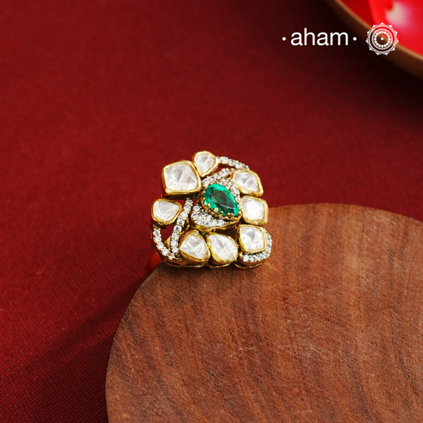 Crafted from 92.5% sterling silver with a rich gold polish, this ring showcases a captivating green emerald-like center stone. Surrounding it, moissanite stones add exceptional sparkle and brilliance, enhancing the ring’s luxurious appeal. Designed with precision, this piece offers a perfect blend of elegance and glamour for discerning jewellery enthusiasts.