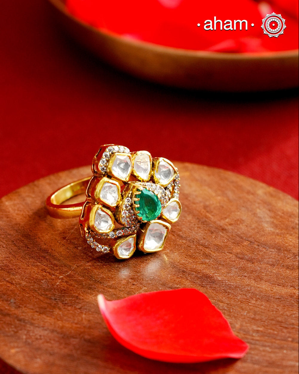 Crafted from 92.5% sterling silver with a rich gold polish, this ring showcases a captivating green emerald-like center stone. Surrounding it, moissanite stones add exceptional sparkle and brilliance, enhancing the ring’s luxurious appeal. Designed with precision, this piece offers a perfect blend of elegance and glamour for discerning jewellery enthusiasts.