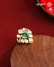 Crafted from 92.5% sterling silver with a rich gold polish, this ring showcases a captivating green emerald-like center stone. Surrounding it, moissanite stones add exceptional sparkle and brilliance, enhancing the ring’s luxurious appeal. Designed with precision, this piece offers a perfect blend of elegance and glamour for discerning jewellery enthusiasts.