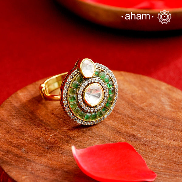 This exquisite ring features a dazzling moissanite center stone, surrounded by vibrant green emerald-like stones that enhance its elegance. Expertly crafted in 92.5% sterling silver with a fin gold polish. Perfect for those seeking a sophisticated accessory that combines timeless design with exceptional craftsmanship.