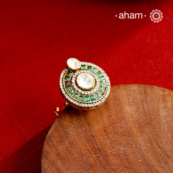 This exquisite ring features a dazzling moissanite center stone, surrounded by vibrant green emerald-like stones that enhance its elegance. Expertly crafted in 92.5% sterling silver with a fin gold polish. Perfect for those seeking a sophisticated accessory that combines timeless design with exceptional craftsmanship.