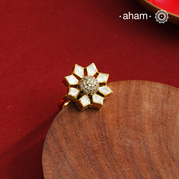 This expertly handcrafted silver ring showcases a brilliant moissanite stone set against a refined gold-polished finish. Its adjustable band offers a personalized fit, making it a sophisticated choice for special occasions and festive events. Combining artisanal craftsmanship with timeless elegance, this ring enhances any ensemble with subtle luxury.