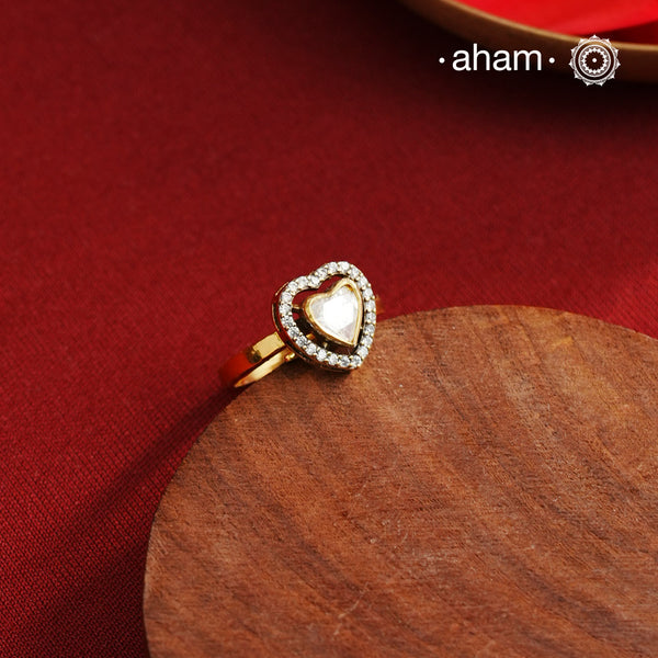 This expertly crafted heart-shaped ring showcases a brilliant moissanite center stone, encircled by finely set American diamonds. Made from high-quality 925 sterling silver and enhanced with a rich gold polish, the piece offers elegant shine. Ideal for those seeking a sophisticated accessory that combines classic design with exceptional craftsmanship.