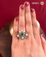 Crafted from 92.5% sterling silver with a rich gold polish, this ring showcases a captivating green emerald-like center stone. Surrounding it, moissanite stones add exceptional sparkle and brilliance, enhancing the ring’s luxurious appeal. Designed with precision, this piece offers a perfect blend of elegance and glamour for discerning jewellery enthusiasts.