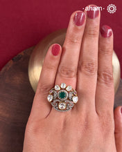 Crafted from 92.5% sterling silver with a rich gold polish, this ring showcases a captivating green emerald-like center stone. Surrounding it, moissanite stones add exceptional sparkle and brilliance, enhancing the ring’s luxurious appeal. Designed with precision, this piece offers a perfect blend of elegance and glamour for discerning jewellery enthusiasts.