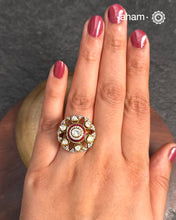 This exquisite ring features dazzling moissanites set within an elegant flower design, accented by vibrant red meena work. Crafted from 92.5% sterling silver and enhanced with a refined gold polish, for a luxurious finish. Perfect for those seeking a sophisticated blend of classic craftsmanship and contemporary style.