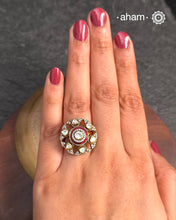 This exquisite ring features dazzling moissanites set within an elegant flower design, accented by vibrant red meena work. Crafted from 92.5% sterling silver and enhanced with a refined gold polish, for a luxurious finish. Perfect for those seeking a sophisticated blend of classic craftsmanship and contemporary style.