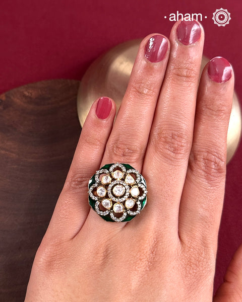 This exquisite ring features a dazzling moissanite center set within an elegant flower design, accented by deep green stones. Crafted from 92.5% sterling silver and enhanced with a refined gold polish, for a luxurious finish. Perfect for those seeking a sophisticated blend of classic craftsmanship and contemporary style.
