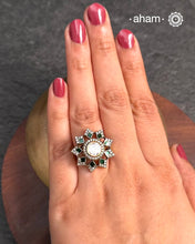 This exquisite ring features a dazzling moissanite ring with an elegant flower design, accented by green stones. Crafted from 92.5% sterling silver and enhanced with a refined gold polish, for a luxurious finish. Perfect for those seeking a sophisticated blend of classic craftsmanship and contemporary style.