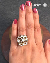 This exquisite ring features dazzling moissanite stones set within an elegant flower design. Crafted from 92.5% sterling silver and enhanced with a refined gold polish, for a luxurious finish. Perfect for those seeking a sophisticated blend of classic craftsmanship and contemporary style.