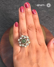 Crafted from 92.5% sterling silver with a rich gold polish, this ring showcases a captivating green emerald center stone. Surrounding it, moissanite stones add exceptional sparkle and brilliance, enhancing the ring’s luxurious appeal. Designed with precision, this piece offers a perfect blend of elegance and glamour for discerning jewellery enthusiasts.