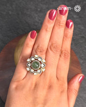 Crafted from 92.5% sterling silver with a rich gold polish, this ring showcases a captivating green emerald center stone. Surrounding it, moissanite stones add exceptional sparkle and brilliance, enhancing the ring’s luxurious appeal. Designed with precision, this piece offers a perfect blend of elegance and glamour for discerning jewellery enthusiasts.