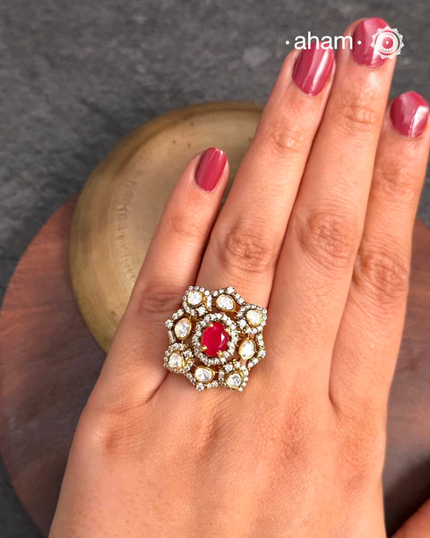 This exquisite ring features dazzling moissanites set within an elegant flower design, accented by vibrant deep red stone center. Crafted from 92.5% sterling silver and enhanced with a refined gold polish, for a luxurious finish. Perfect for those seeking a sophisticated blend of classic craftsmanship and contemporary style.