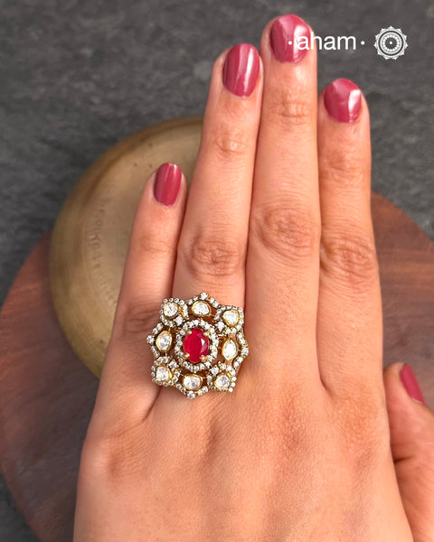 This exquisite ring features dazzling moissanites set within an elegant flower design, accented by vibrant deep red stone center. Crafted from 92.5% sterling silver and enhanced with a refined gold polish, for a luxurious finish. Perfect for those seeking a sophisticated blend of classic craftsmanship and contemporary style.