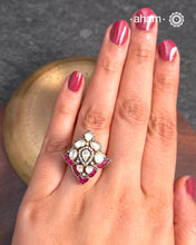 This exquisite ring features a dazzling moissanite stones set within an elegant design, accented by vibrant fuchsia pink stones. Crafted from 92.5% sterling silver and enhanced with a refined gold polish, for a luxurious finish. Perfect for those seeking a sophisticated blend of classic craftsmanship and contemporary style.