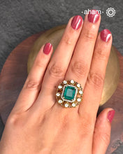 Crafted from 92.5% sterling silver with a rich gold polish, this ring showcases a captivating green emerald-like center stone. Surrounding it, moissanite stones add exceptional sparkle and brilliance, enhancing the ring’s luxurious appeal. Designed with precision, this piece offers a perfect blend of elegance and glamour for discerning jewellery enthusiasts.