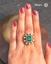 Crafted from 92.5% sterling silver with a rich gold polish, this ring showcases a captivating green emerald-like center stone. Surrounding it, moissanite stones add exceptional sparkle and brilliance, enhancing the ring’s luxurious appeal. Designed with precision, this piece offers a perfect blend of elegance and glamour for discerning jewellery enthusiasts.