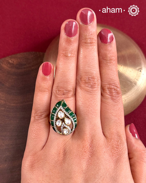 This exquisite ring features moissanite along with deep green stone highlights. Crafted from 92.5% sterling silver and enhanced with a refined gold polish, for a luxurious finish. Perfect for those seeking a sophisticated blend of classic craftsmanship and contemporary style.