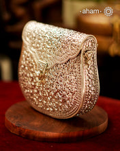 Handcrafted 92.5 sterling silver clutch with intricate floral carvings. Statement bags perfect for festive occasions, carry your accessories in style.