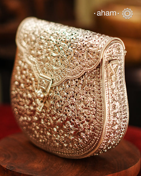 Handcrafted 92.5 sterling silver clutch with intricate floral carvings. Statement bags perfect for festive occasions, carry your accessories in style.