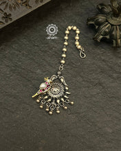 Beautiful Maang Tikka crafted in silver with a gold toned kundan parrot highlight.