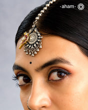 Beautiful Maang Tikka crafted in silver with a gold toned kundan parrot highlight.