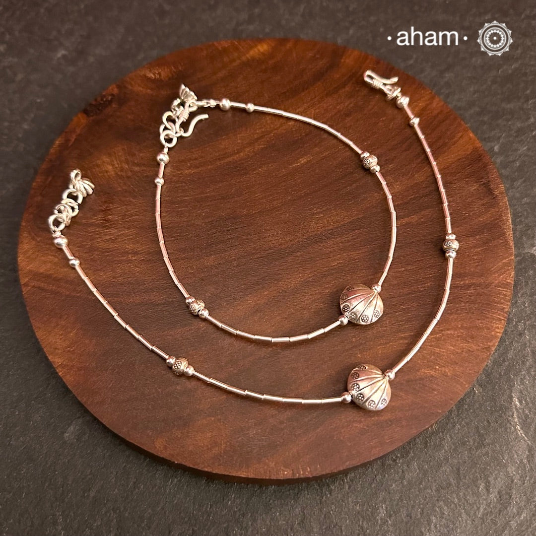 Versatile, fun, unmistakably you! Stunning silver anklet with little charms crafted in fine 92.5 silver. Dress your feet with these delicate and beautiful statement anklets.
The price is for a pair