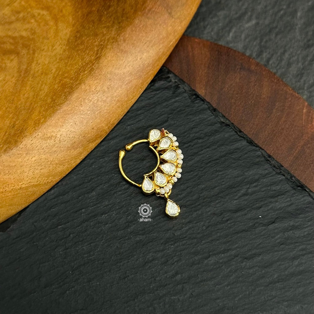 Beautiful clip on nath with fine kundan work, Crafted in silver with gold polish.
Sits on the left side of the nostril.