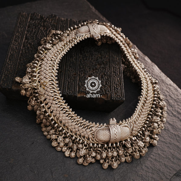 Anklets have a charm of their own and add loads of grace to your feet. Beautiful tribal silver anklets with bunch of statement ghungroos. We recomend that you can join the two anklets togther and wear it as a neckpiece. 