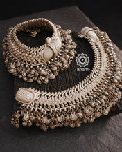 Anklets have a charm of their own and add loads of grace to your feet. Beautiful tribal silver anklets with bunch of statement ghungroos. We recomend that you can join the two anklets together and wear it as a neckpiece