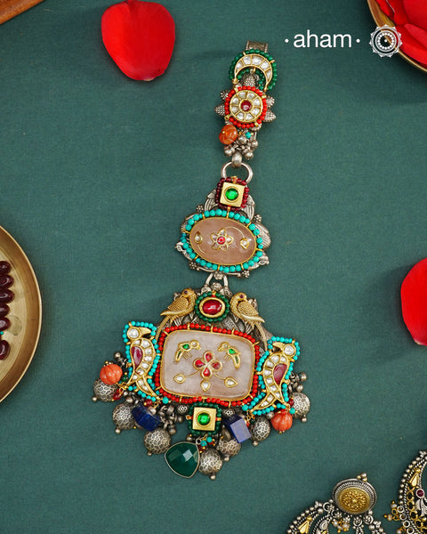 Challa/Juda/Chatka/ Guchha or waist key chains hold a special place in a woman’s trousseau, symbolizing tradition and elegance. The Noori Two Tone Silver Waist Key Ring features exquisite kundan work and carefully selected fine stones, all crafted in high-quality silver. This unique piece blends timeless craftsmanship with distinctive design, making it a meaningful accessory that complements your individuality.