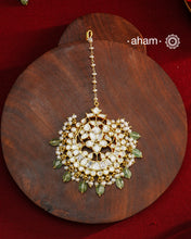 Crafted from 92.5% sterling silver with a fine gold polish finish, this maang tikka features brilliant moissanite stones that enhance its radiant appeal. Designed for enduring shine and elegance, it is an ideal accessory to complement your ensemble on special occasions.