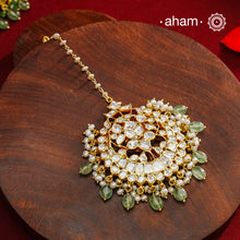 Crafted from 92.5% sterling silver with a fine gold polish finish, this maang tikka features brilliant moissanite stones that enhance its radiant appeal. Designed for enduring shine and elegance, it is an ideal accessory to complement your ensemble on special occasions.