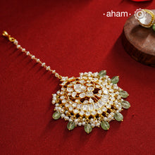Crafted from 92.5% sterling silver with a fine gold polish finish, this maang tikka features brilliant moissanite stones that enhance its radiant appeal. Designed for enduring shine and elegance, it is an ideal accessory to complement your ensemble on special occasions.