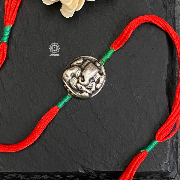 Beautiful Silver Rakhi. Make this Rakshabandhan Memorable with this handcrafted Rakhi for an ever-lasting Knot.  Elegant Ganesh Symbol Rakhi in 925 Silver dial weaved with Multi Colour cotton thread.   Tip: you can later convert this into a key chain charm or a pendant as well  Roli and Chawal shipped along with India orders only.  Please note, Rakhi Orders will be packed and shipped in a single box only and not multiple boxes.