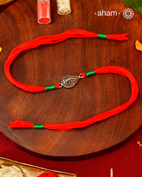 Beautiful Flower Rakhi crafted in silver.
Make this Rakshabandhan Memorable with this handcrafted Rakhi for an ever-lasting Knot and the Eternal protection of Lord Shiva.

Tip: you can later convert this into a key chain charm or a pendant as well

Roli and Akshat (kumkum chawal) shipped along with India orders only