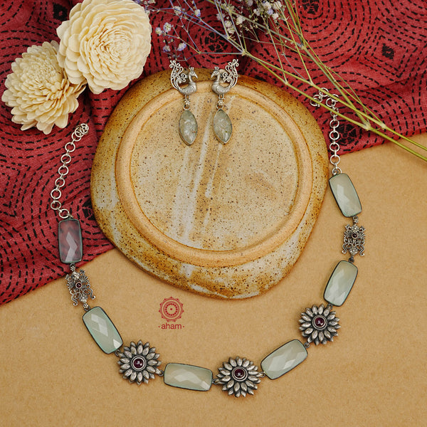 Handcrafted 92.5 sterling silver neckpiece and earrings set. Pendant with intricate amulet, floral stone setting, double peacock motif and cultured pearls.