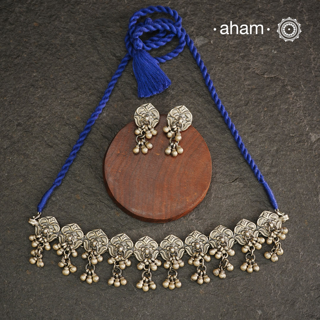 This Mewad Flower Silver Choker and Earring Set showcases expert craftsmanship in sterling silver, featuring intricate floral motifs inspired by traditional Mewad designs. The set is enhanced with delicate ghungroos that add subtle movement and a melodic charm. Perfect for elevating both ethnic and contemporary outfits, this classic combination offers timeless elegance and artisanal detail.