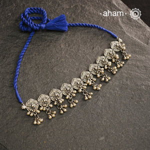 This Mewad Flower Silver Choker and Earring Set showcases expert craftsmanship in sterling silver, featuring intricate floral motifs inspired by traditional Mewad designs. The set is enhanced with delicate ghungroos that add subtle movement and a melodic charm. Perfect for elevating both ethnic and contemporary outfits, this classic combination offers timeless elegance and artisanal detail.