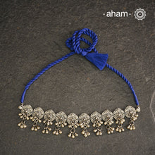 This Mewad Flower Silver Choker and Earring Set showcases expert craftsmanship in sterling silver, featuring intricate floral motifs inspired by traditional Mewad designs. The set is enhanced with delicate ghungroos that add subtle movement and a melodic charm. Perfect for elevating both ethnic and contemporary outfits, this classic combination offers timeless elegance and artisanal detail.