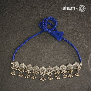 This Mewad Flower Silver Choker and Earring Set showcases expert craftsmanship in sterling silver, featuring intricate floral motifs inspired by traditional Mewad designs. The set is enhanced with delicate ghungroos that add subtle movement and a melodic charm. Perfect for elevating both ethnic and contemporary outfits, this classic combination offers timeless elegance and artisanal detail.