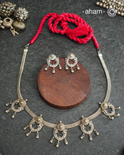 The Mewad Silver Neckpiece &amp; Earrings Set showcases expertly crafted silver paired with delicate ghungroos, designed to complement professional attire effortlessly. This lightweight and elegant set brings a refined cultural touch to your workwear, ensuring comfort and sophisticated style throughout your busy day.