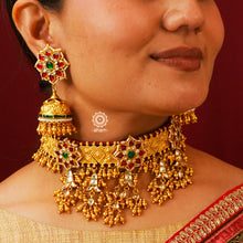 Beautiful floral choker, jhumka and ring set with gold polish and red kundan work. Handcrafted using traditional kundan jadua techniques in 92.5 sterling silver with dangling ghungroos. The ring is adjustable and has a flower motif with embellished cultured pearls. Perfect for intimate weddings and upcoming festive celebrations.