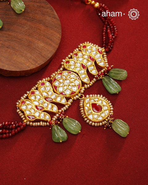Make a sophisticated style statement this festive season with our beautiful gold polish neckpiece and earrings set. Crafted using traditional jadau kundan techniques in silver with green semi precious beads and cultured pearls. Perfect for intimate weddings and upcoming festive celebrations.