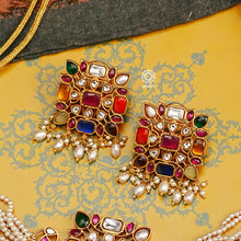 This beautiful Navratna Kundan & Pearl Gold Polish Silver Choker Set has a timeless appeal. Handcrafted to perfection, this piece is a great addition to ones wardrobe.   Traditionally the Navratna is believed to carry scientific and astrological benefits. Wearing this ornamental set is said to enhance the wearer's health, wealth and happiness, protecting them from negative energy.