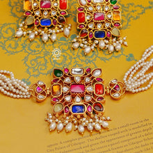 This beautiful Navratna Kundan & Pearl Gold Polish Silver Choker Set has a timeless appeal. Handcrafted to perfection, this piece is a great addition to ones wardrobe.   Traditionally the Navratna is believed to carry scientific and astrological benefits. Wearing this ornamental set is said to enhance the wearer's health, wealth and happiness, protecting them from negative energy.